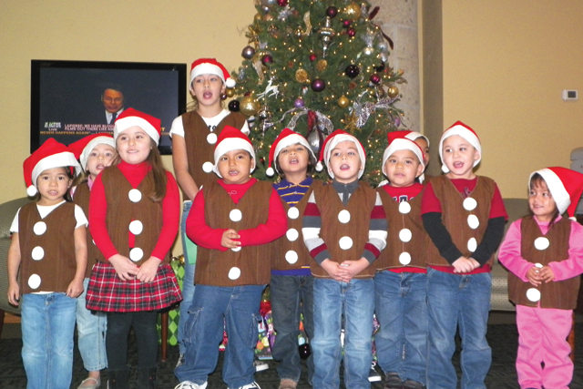 Children Christmas carolers from Spirit of Joy Daycare in San Benito paid First Community Bank a special visit on Friday morning to sprinkle a little holiday cheer with their take on classic jingles. (Staff photos by Heather Cathleen Cox)