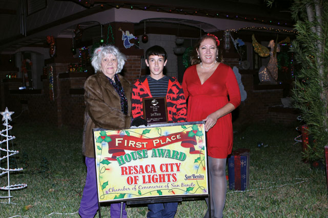 The Ida Martinez home, on Sam Houston Blvd., was awarded first place in the Pride Lights Contest by the San Benito Pride Committee. Seen are Bertha Wilson of the Pride Committee, and Derrick and Debbie Layton of the Pride Committee. (Photos by T.J. Tijerina)