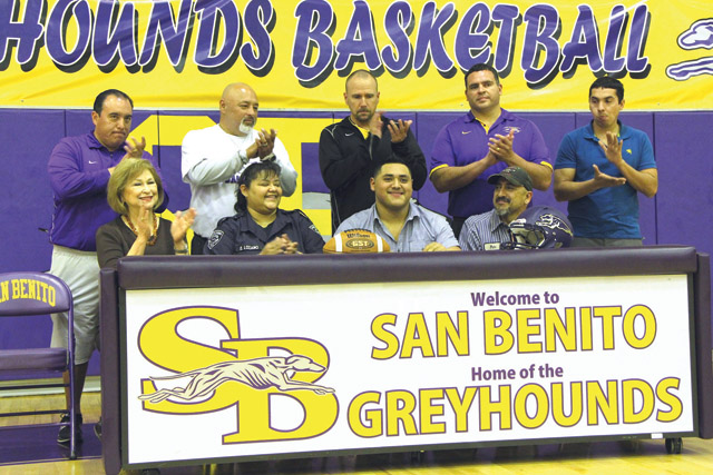 San Benito High School senior Pedro Lozano, first row, third from left, signed a letter of intent to play football for Central Methodist University in Missouri. Joining Lozano are front, from left, San Benito High School Principal Delia Weaver, Lozano’s parents, Estella Vargas Lozano and Pedro Lozano, back, coaching staff Joel Lopez, Ramiro Partida, Athletic Director/Head Football Coach Spencer Gantt, Jesse Treviño and Javier De Dios. (SBCISD photo)