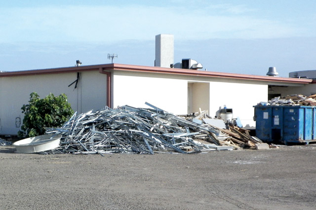 The rear of the former Dolly Vinsant Memorial Hospital reveals that aluminum has been removed from the facility during renovations Tuesday. (Photo by Joe Bocanegra)
