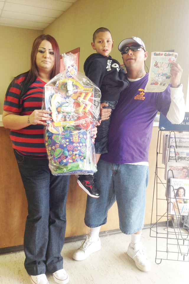 Seven-year-old Isaiah Franco of San Benito is seen with his parents Robert Franco and Victoria Rendon, his winning San Benito News Easter Coloring Contest entry and his Easter basket prize. (Staff photo by Michael Rodriguez)
