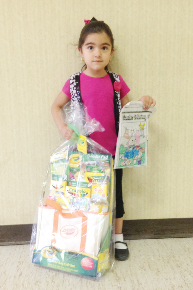 Nine-year-old Jasmine Quiroga of San Benito is seen with her winning San Benito News Easter Coloring Contest entry and her Easter basket prize. (Staff photo by Michael Rodriguez)
