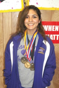 San Benito Lady Greyhound varsity wrestler Valeria Torres is seen with numerous medals she’s won throughout her high school grappling career. Recently, Torres won the bronze medal at the State Wrestling Meet. (Staff photo by Francisco E. Jimenez)