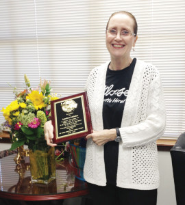 Anneliese McMinn is seen Saturday with a plaque recognizing her years of service as a superintendent and educator at Rio Hondo ISD. (Courtesy photo)