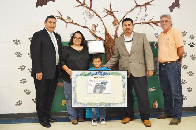 Rio Hondo City Administrator Ben Medina, Jr., Elaine Escamilla and her son Ryan Salazar, winner of the 2013 Texas Department of State Health Services Zoonosis Rabies Awareness and Prevention Poster Contest, are seen along with Cameron County Department of Health and Human Services Environmental Health Director and Rio Hondo Mayor Gustavo “Gus” Olivares as well as Rio Hondo Commissioner, Place 3, Gerald “Jerry” Hartzog. (Courtesy photo)