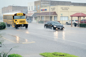 San Benito News photo by Francisco E. Jimenez Shown is a scene from Monday’s downpour in San Benito in which motorists traveling through downtown Sam Houston Boulevard took precautions as the often busy thoroughfare quickly began to flood. 