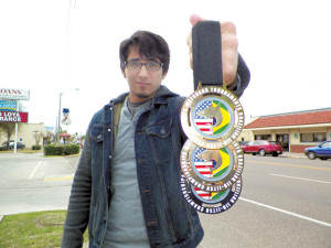 San Benito News photo by Michael Rodriguez Micky Gonzales, 20, of San Benito is seen downtown Sam Houston Boulevard with the medals he won at a recent MatShark jiu-jitsu tournament.