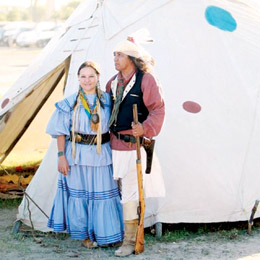 Courtesy photo Anabeth and Ruben Cordova are seen in front of an American Indian tipi. Anabeth is dressed in a traditional Apache cloth dress; Ruben is wearing an Apache warrior’s apparel.