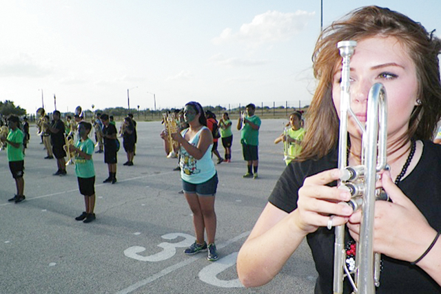 (Photo by Mathew Zuniga) Members of the Rio Hondo High School Marching Band are seen standing at attention during their Summer Showcase on Thursday, Aug. 21.
