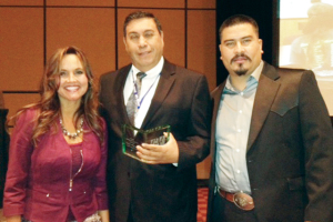(Courtesy photo) Rio Hondo Mayor Gustavo Olivares is seen (right) accepting recognition on behalf of the city at a conference in Plano, Texas on Friday.